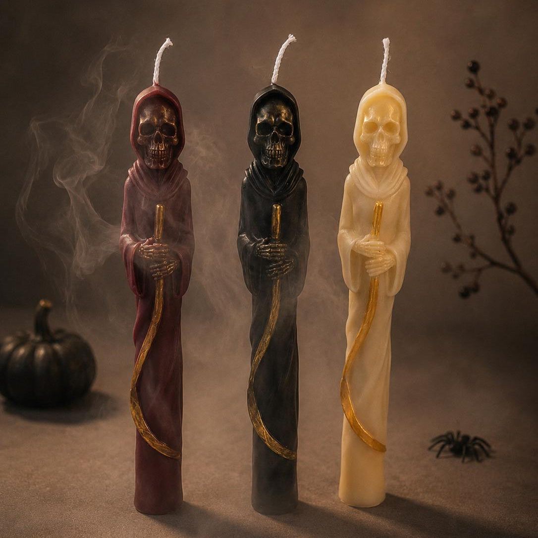 Three Grim Reaper candles with scythes in ivory, burgundy, and black surrounded by atmospheric smoke.