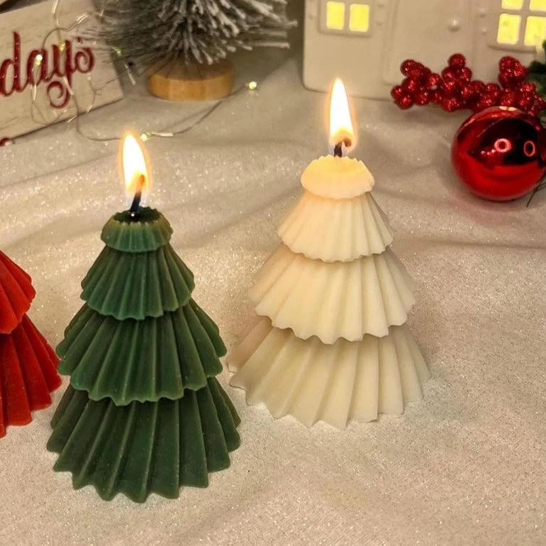 White and green Christmas tree candles burning with warm flames