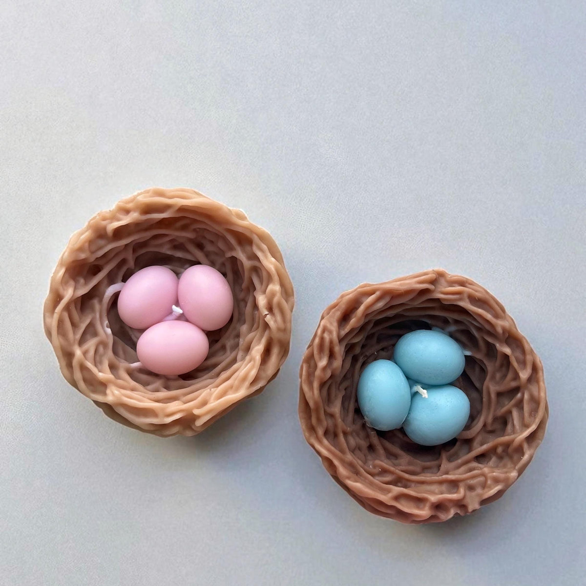 Handmade bird nest soy candles with pastel eggs for spring home decor
