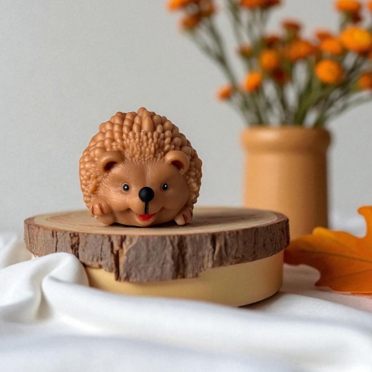 Handmade hedgehog soy candle with autumn home decor on a wooden display