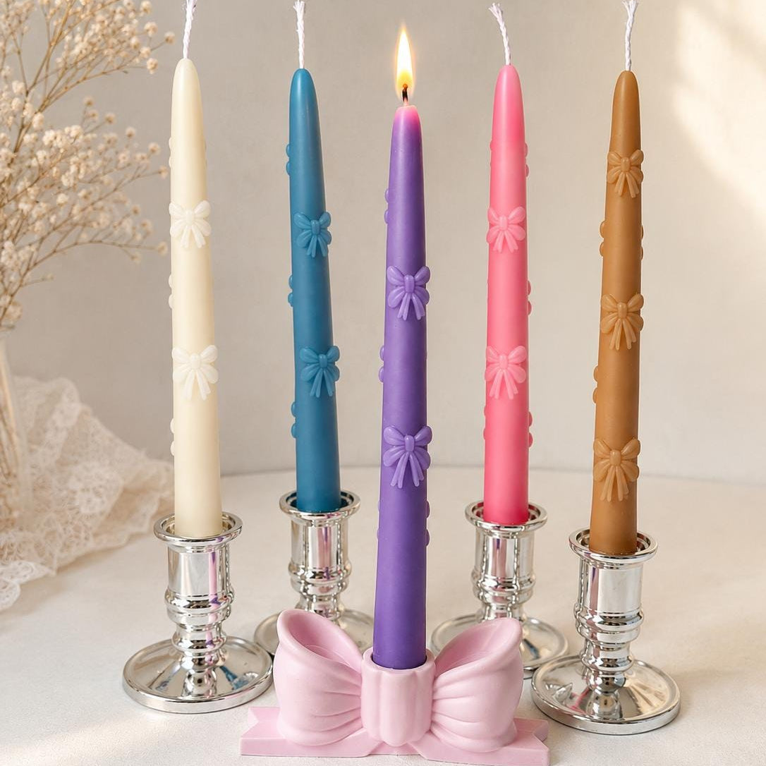 Five decorative taper candles in cream, blue, purple, pink, and brown